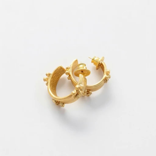 Gold-tone C hoop earrings with embossed flower accents and stud posts
