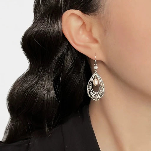 Freshwater pearl teardrop drop earrings with ornate openwork detail on ear