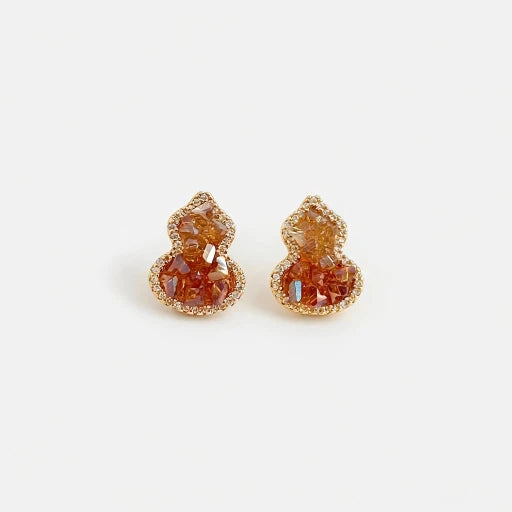 Pair of amber orange crystal gourd stud earrings with rhinestone halo and small posts