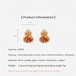 Amber orange crystal gourd stud earrings with micro-set rhinestone sparkle, gold-tone posts