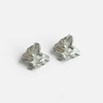 Pair of silver-tone freshwater pearl stud earrings with irregular sculpted shape