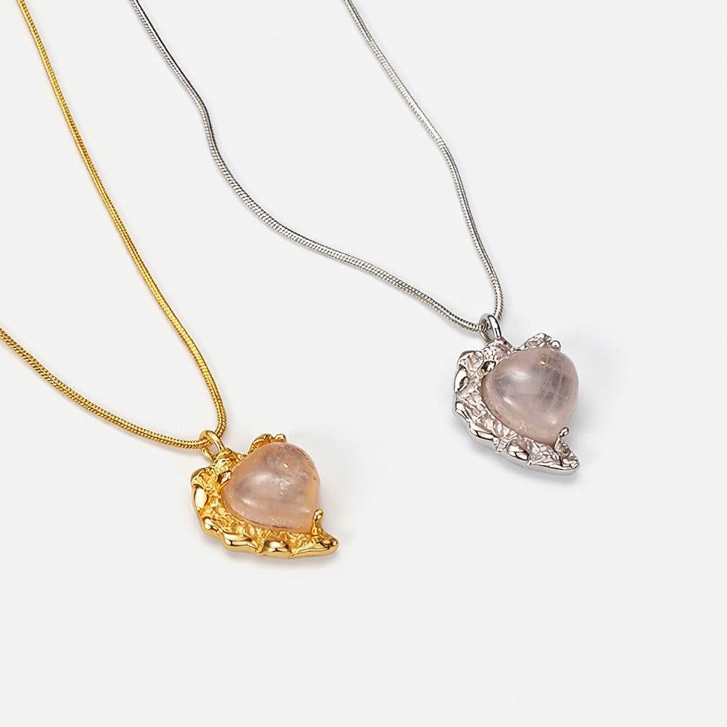 Gold and silver snake chain necklace with heart-shaped agate pendant in ornate setting