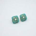 Pair of turquoise beaded stud earrings with gold-tone woven lattice center