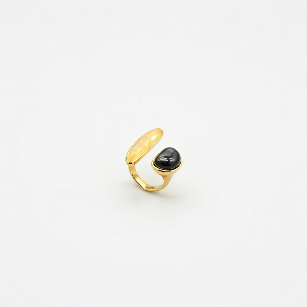 Gold-tone open irregular ring with black oval cabochon gemstone