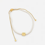 Pearl drawstring necklace with gold square tag and faux pearl beads