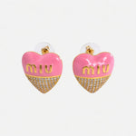 Miu Miu pink heart-shaped enamel earrings with gold logo and crystal-paved lower half
