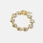 Gold bracelet with round blue crystal links and toggle clasp