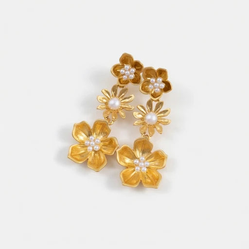 Gold-plated plum blossom drop earrings with white enamel flowers and pearl centers
