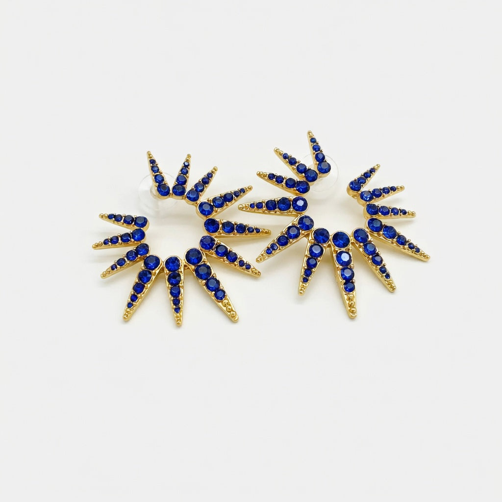 Blue starburst earrings with dark blue stones and gold prongs, pair of two sunbursts