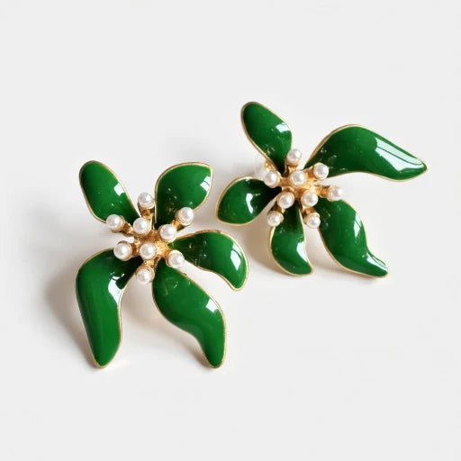 Floral enamel earrings with green enamel petals, pearl beads, and gold-tone setting