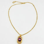 Gold square pendant necklace with hammered texture and purple faceted gemstone