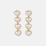 Heart-shaped long earrings with gold-tone links and four white heart charms