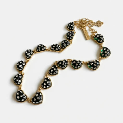 Heart rhinestone necklace, black heart pendants with green accents on gold-tone chain