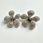 Diamond flower earrings with pave-style stones and scalloped petal shape, stud style