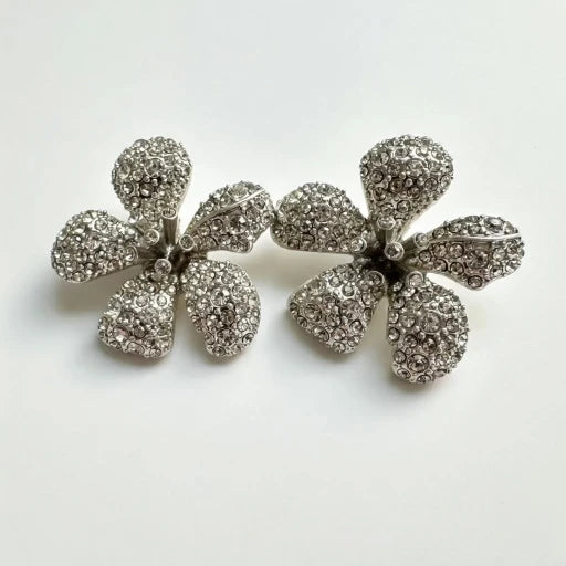 Diamond flower earrings with pave-style stones and scalloped petal shape, stud style
