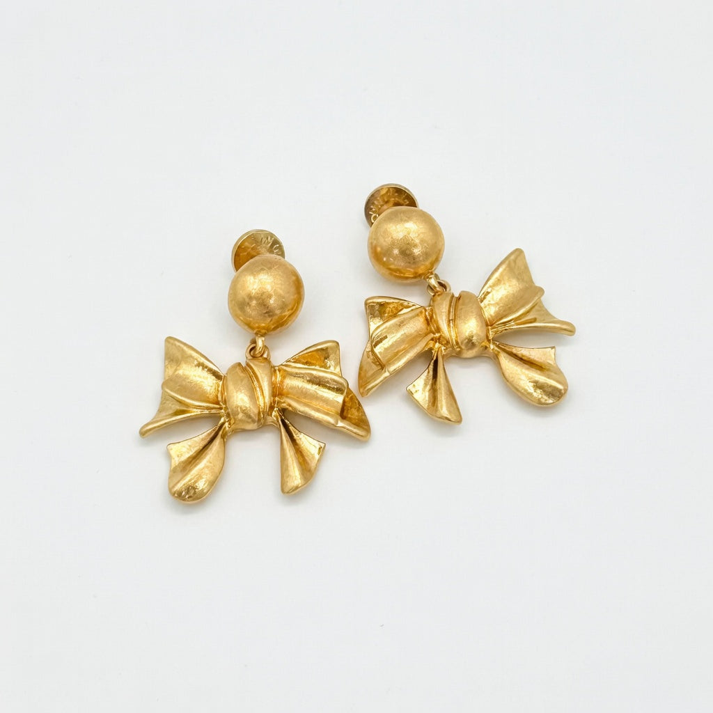 Gold metal bow stud earrings with round stud tops and layered bow charms