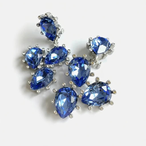 Sparkling glass diamond ear clips with blue oval stones and silver-tone settings