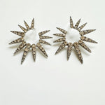 Silver-tone starburst earrings with clear rhinestones, two large spiked sunburst discs