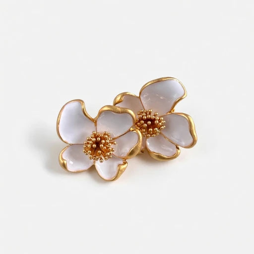 Oscar de la Renta enamel floral stud earrings, white petals with gold-tone frames and bead centers.