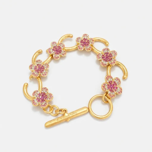 Gold-tone charm bracelet with pink flower pavé links and bar clasp