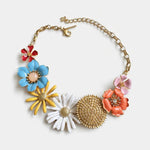 Enamel flower necklace with gold chain, blue and pink daisies, coral blossoms and gold medallion