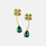 Four-leaf clover teardrop crystal drop earrings with emerald green stones and gold tone hooks.