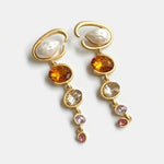 Long crystal drop earrings with amber orange gem drops and clear stones, gold-tone loops