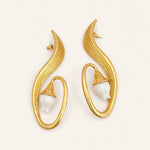 Gold clip-on earrings with white lily centers in curved oval hoops