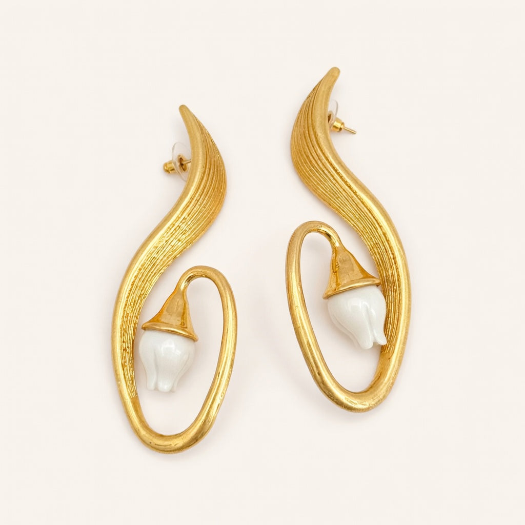 Gold clip-on earrings with white lily centers in curved oval hoops