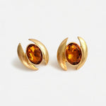 Oval crystal earrings with gold-tone curved settings and orange oval stones