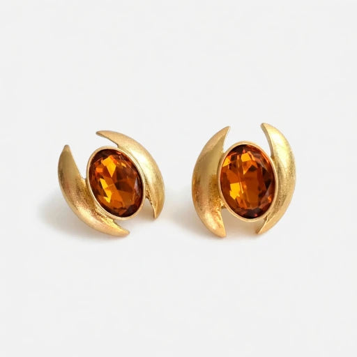 Oval crystal earrings with gold-tone curved settings and orange oval stones