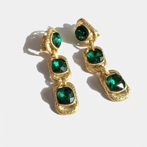 Gold-tone clip-on drop earrings with emerald green square crystals