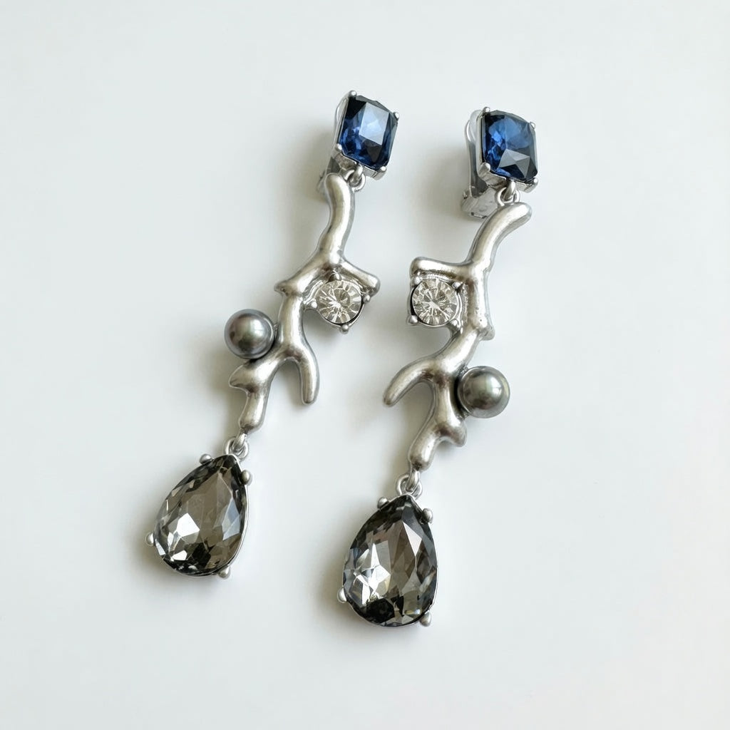 Silver-tone clip-on earrings with blue square crystals, teardrop stones, and gray beads