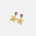 Gold starfish stud earrings with purple jeweled centers