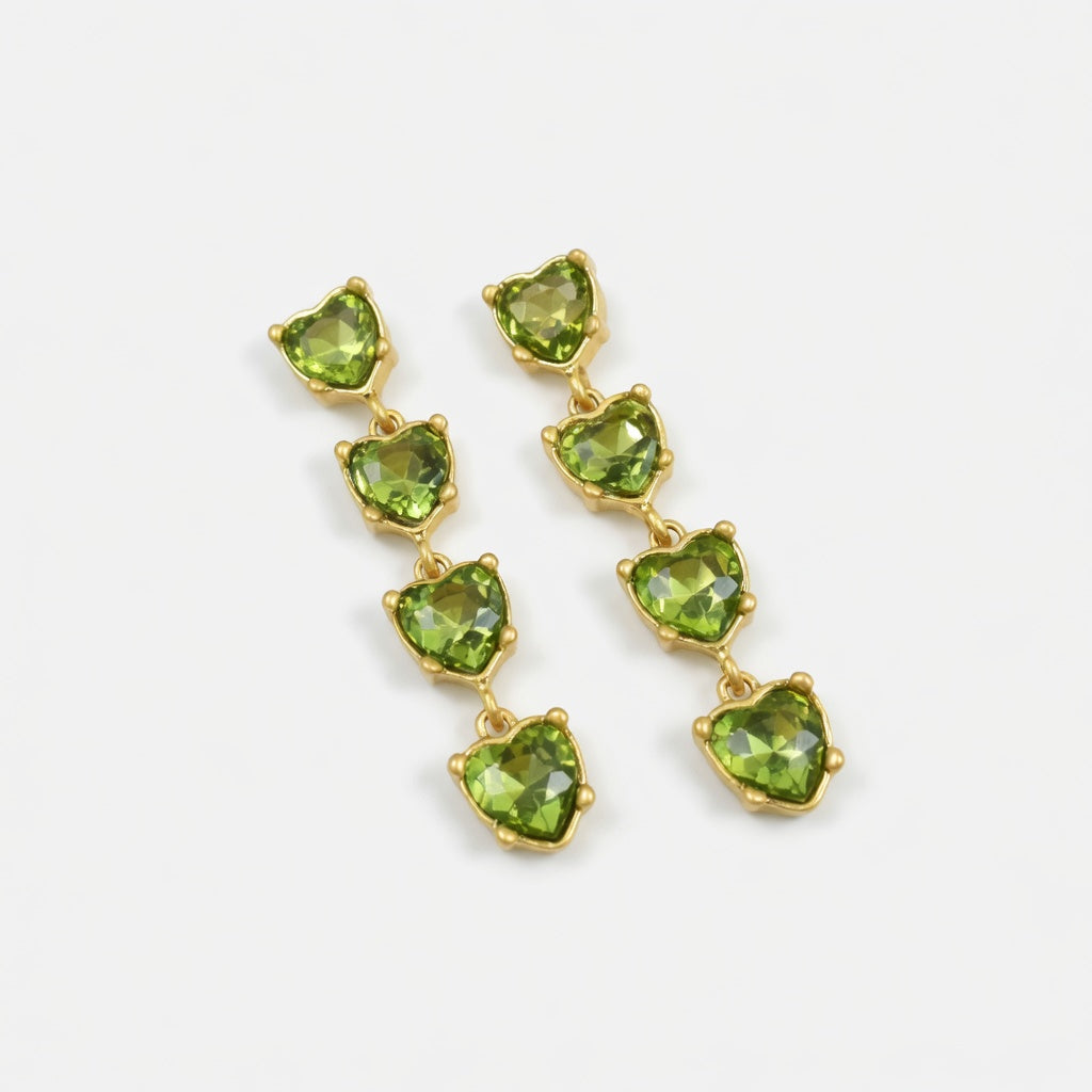 Green heart-shaped crystal drop earrings with gold-tone chain links.