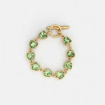 Green crystal heart bracelet with gold-tone toggle clasp and bezel links