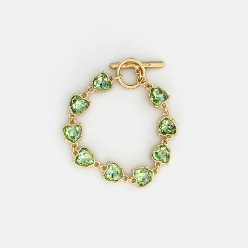 Green crystal heart bracelet with gold-tone toggle clasp and bezel links