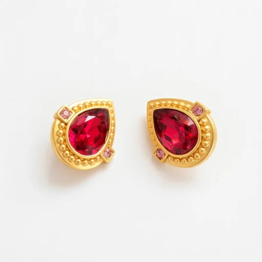 Gold heart-shaped crystal clip-on earrings with red stones and purple accents