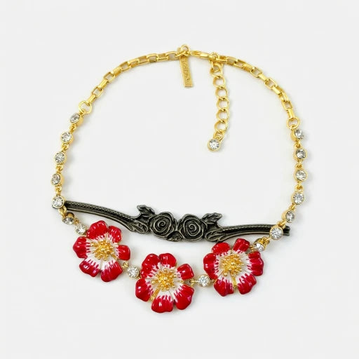 Gold-tone pendant necklace with red enamel flower charms and black decorative bar