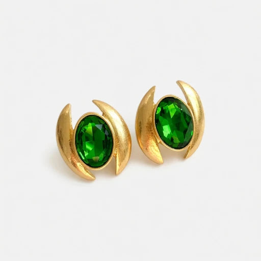Oval crystal stud earrings with vibrant green faceted stones and gold-tone crescent frames