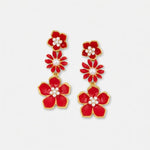 Red enamel plum blossom drop earrings with white pearl centers and gold-tone accents