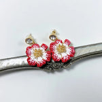 Gold-tone enamel cherry blossom earrings with red petals and crystal center studs