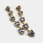 Purple heart-shaped crystal drop earrings with gold-tone chain links.