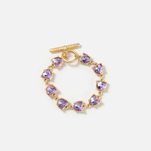 Gold bracelet with purple heart-shaped crystal links and bar clasp