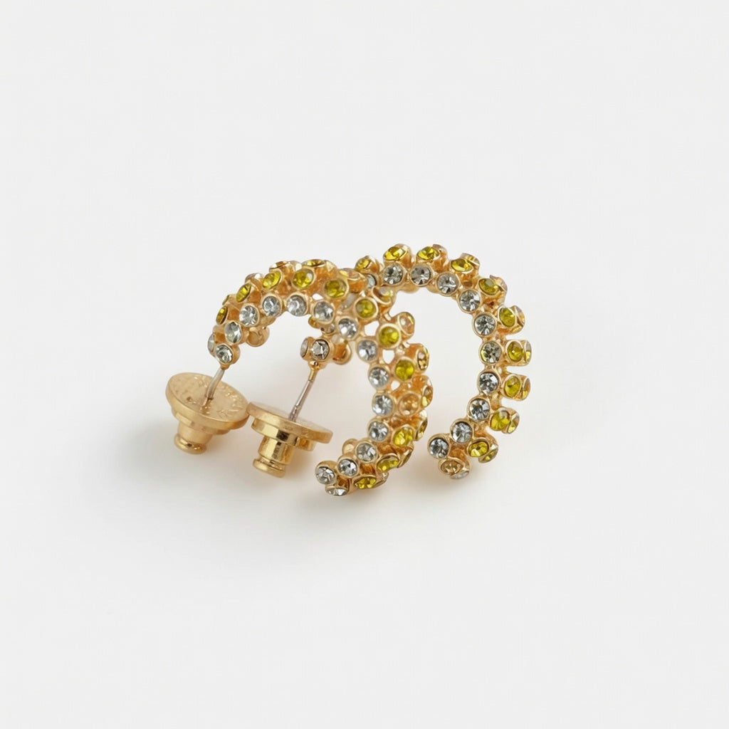 Gold-tone cubic zirconia hoop earrings with clear stones, hinged C-hoop style.
