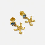 Gold starfish stud earrings with blue jeweled centers