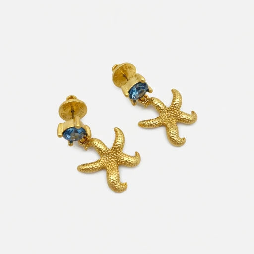 Gold starfish stud earrings with blue jeweled centers