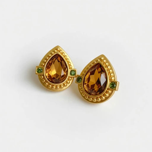 Gold heart-shaped crystal clip-on earrings with amber stones and green accents