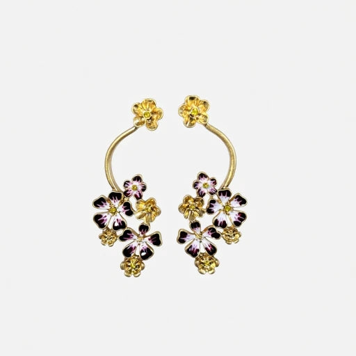 Gold-tone enamel flower hoop earrings with purple, black, and white blooms
