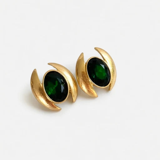 Oval crystal stud earrings with dark green faceted stones and gold-tone crescent bezels